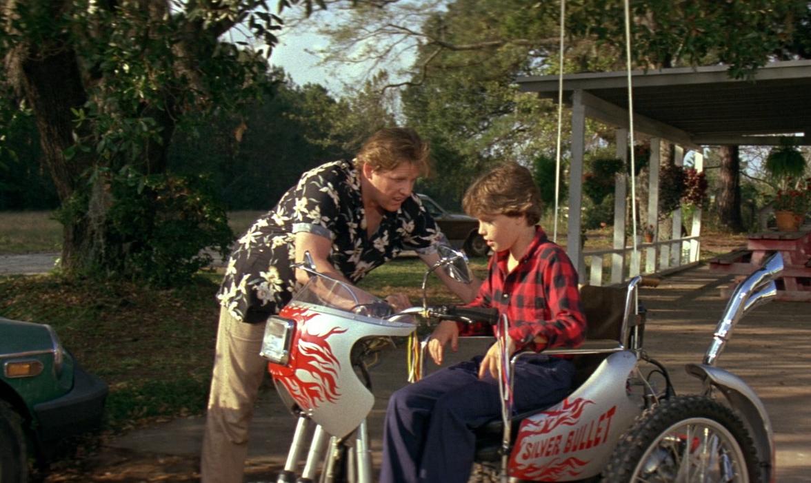 Gary Busey introduces paraplegic Corey Haim to the Silver Bullet