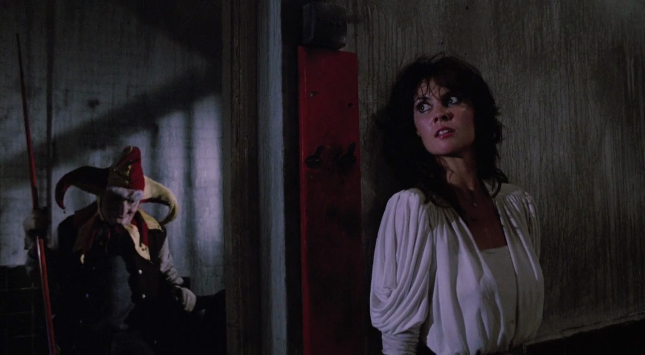 Caroline Munro pursued by Marty in jester costume in Slaughter High (1986)