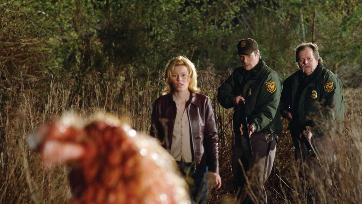 (l to r) Elizabeth Banks, Nathan Fillion and Don Thompson encounter a creature in Slither (2006)