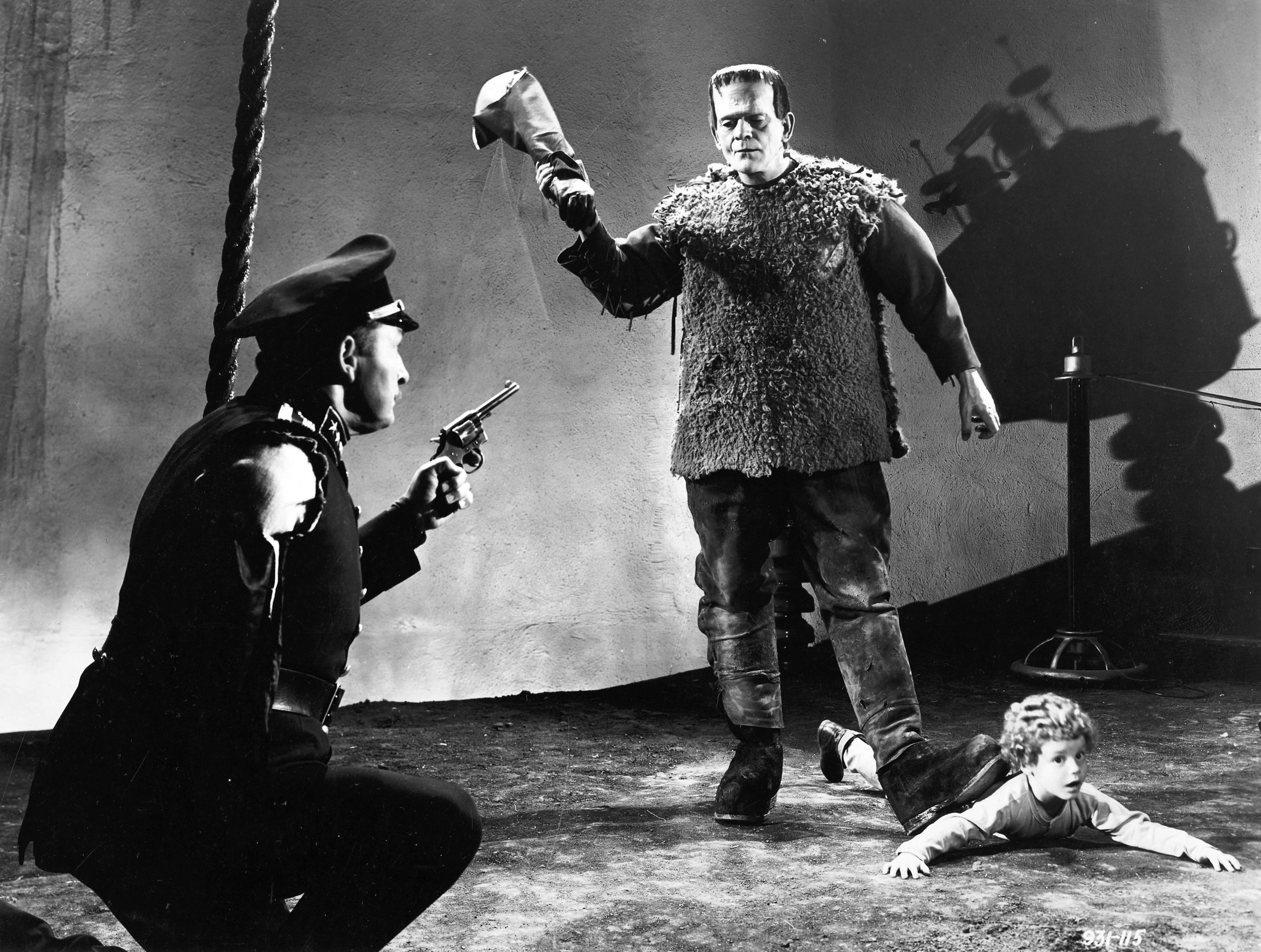 (l to r) Inspector Krogh (Lionel Atwill) attempts to stop the monster (Boris Karloff) as it threatens Frankenstein's son (Donnie Duggan) in Son of Frankenstein (1939)