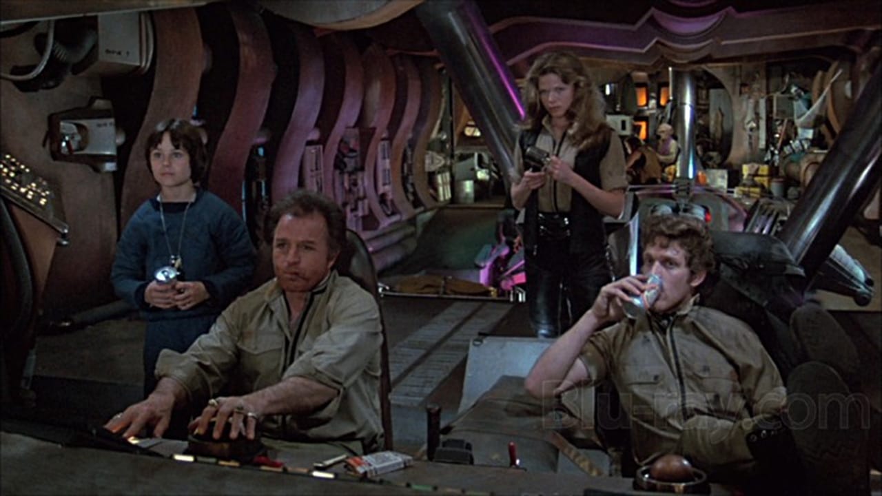 (l to r) Intergalactic runaway Peter (David Mendenhall), Hawk (Vince Edwards) and his crew Patsy Pease and Luca Bercovici in Space Raiders (1983)