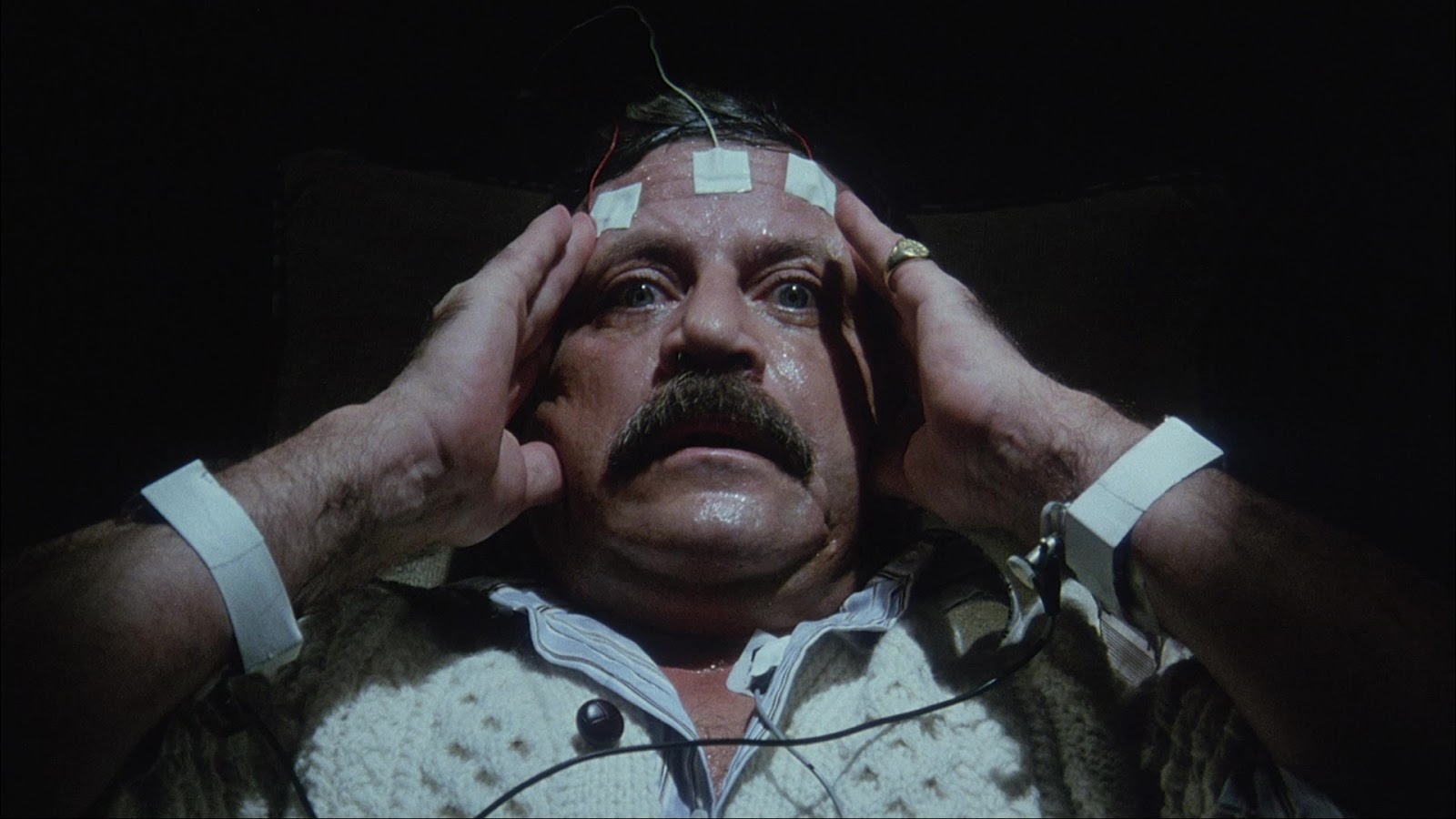 Billionaire Oliver Reed develops a psychic link with a giant snake in Spasms (1983)