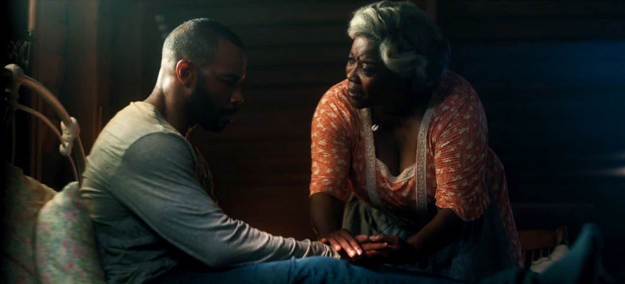 An imprisoned Omari Hardwick and voodoo mambo Loretta Devine in Spell (2020)
