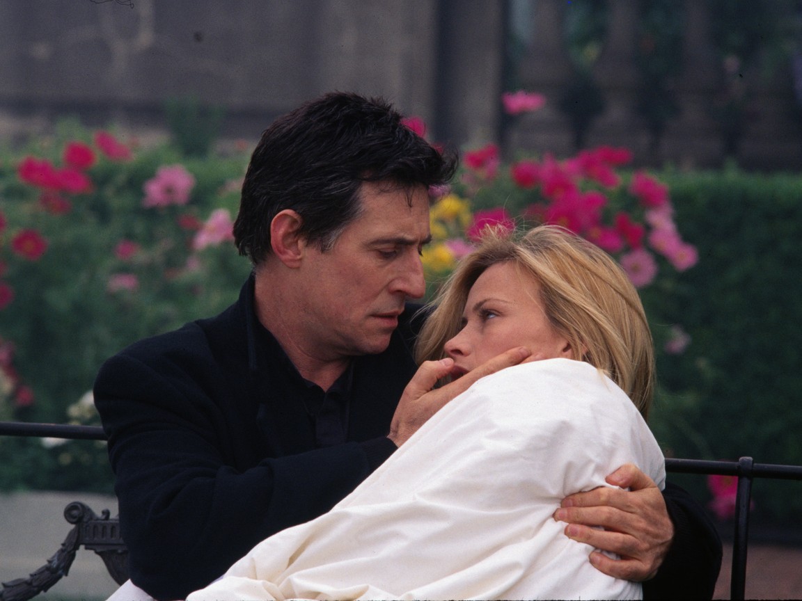 Priest Gabriel Byrne tends to Patricia Arquette in Stigmata (1999)