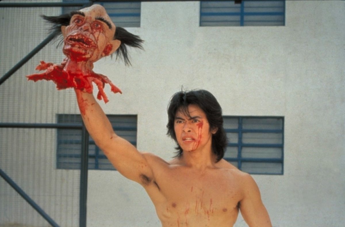 Ricky (Siu-Wong Fan) emerges with the warden's severed head in Story of Ricky (1991)