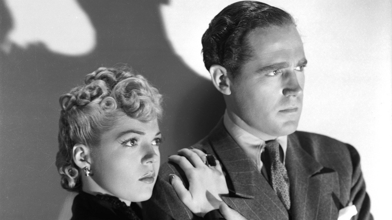 Private detective Jerry Church (Patrick Knowles) and neighbour Kit Logan (Anne Gwynne) in The Strange Case of Doctor Rx (1942)