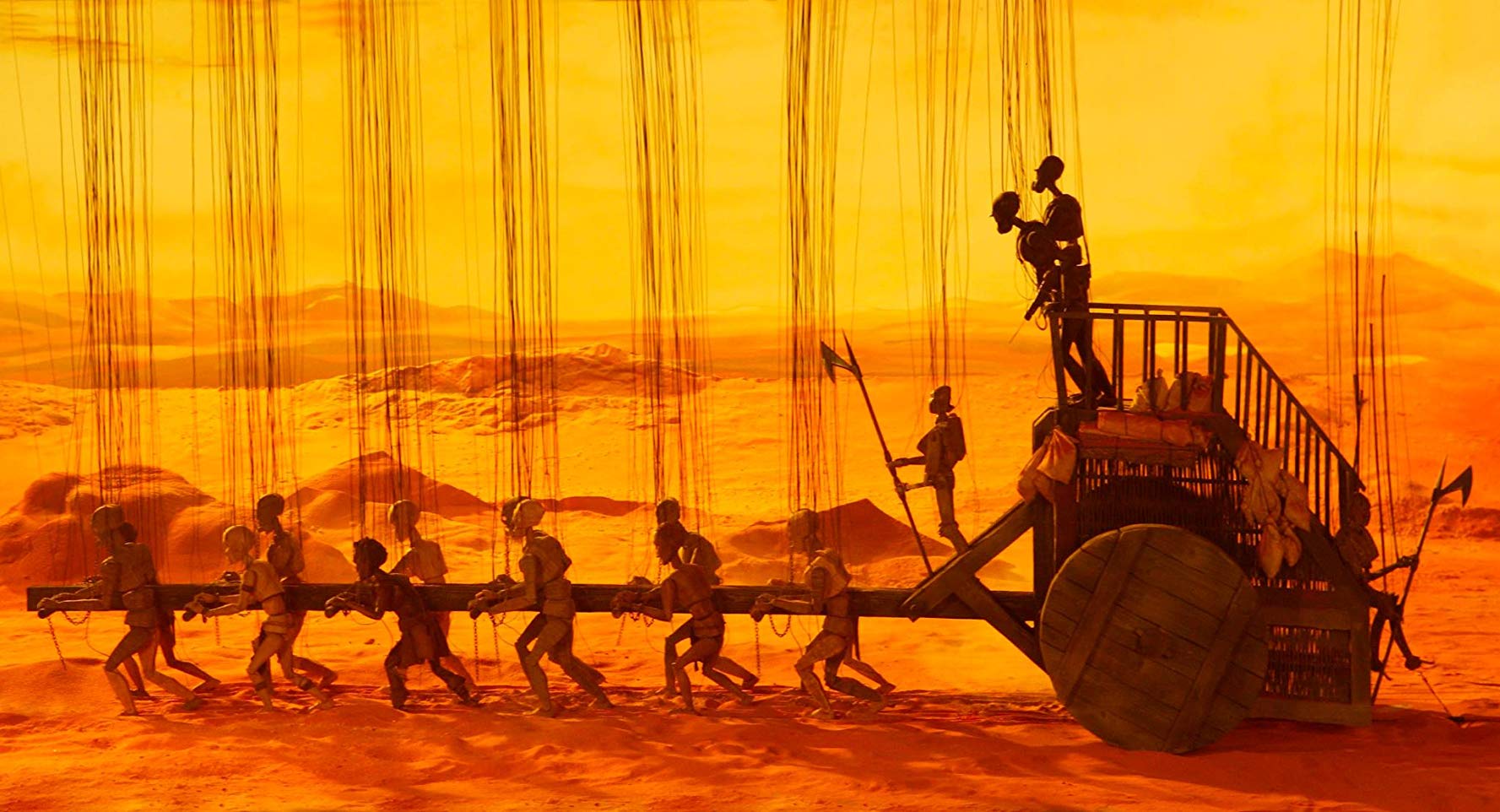 Wagon train pulled by slaves in Strings (2004)