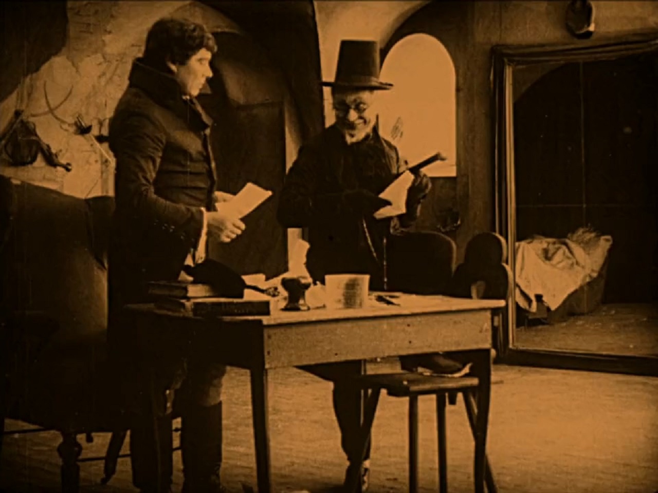 Balduin (Paul Wegener) receives an offer from Scapinelli (John Gottowt) in The Student of Prague (1913)