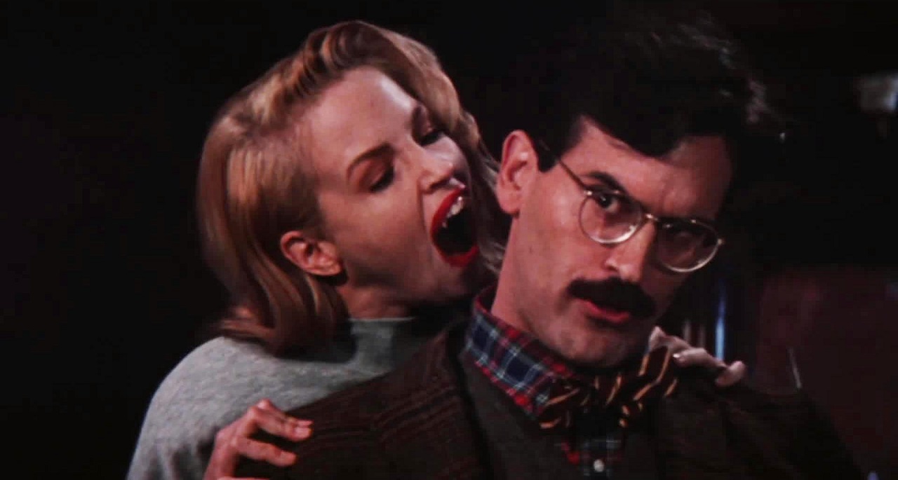 Robert Van Helsing (Bruce Campbell) gets the bite from vampire Deborah Foreman in in Sundown: The Vampire in Retreat (1989)