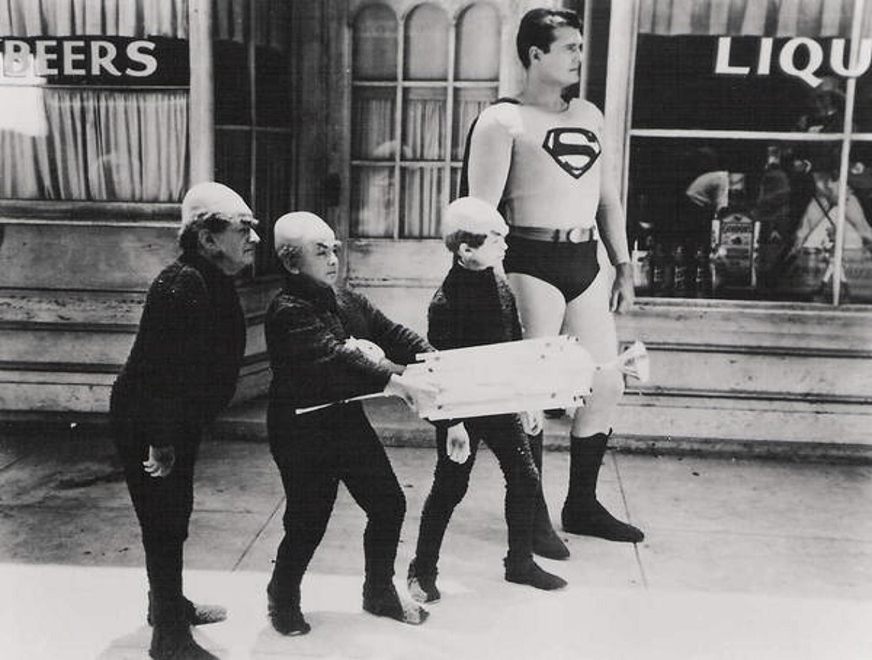 Superman (George Reeves) accompanied by the Mole-Men