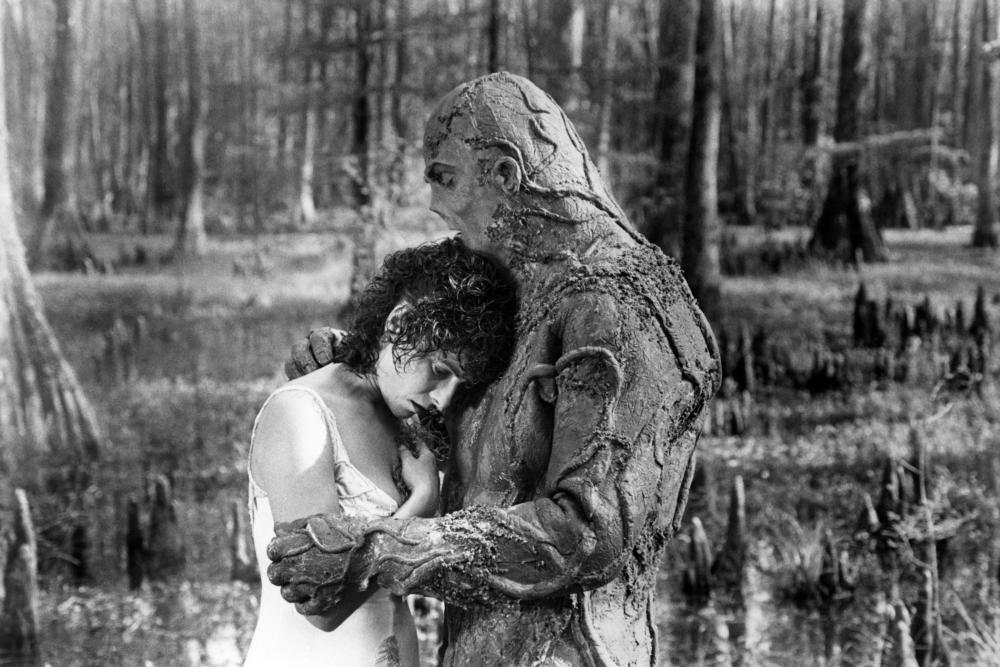 Alice Cable (Adrienne Barbeau) and Swamp Thing (Dick Durock) share a tender moment in Swamp Thing (1982)