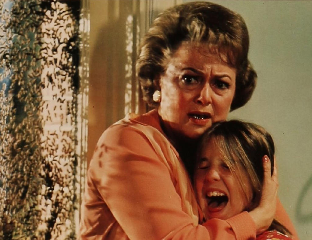 Olivia de Havilland shelters from bee attack in The Swarm (1978)