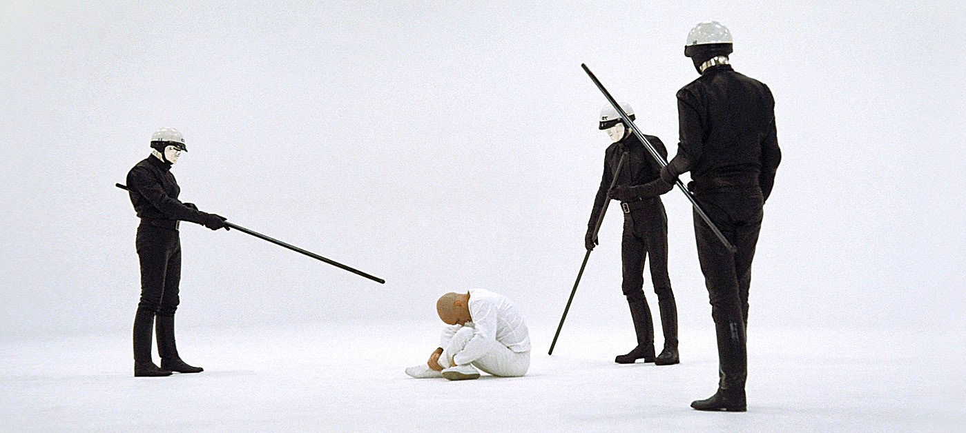 THX 1138 (Robert Duvall) placed in the white void prison by the robot policemen in THX 1138 (1971)