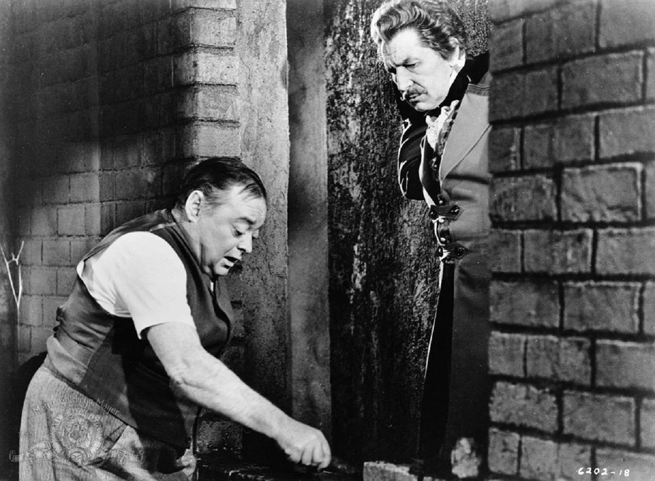 Montresor Herringbone (Peter Lorre) bricks up his wife's lover Fortunato (Vincent Price) in The Black Cat episode of Tales of Terror (1962)