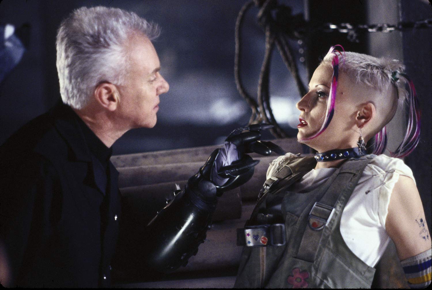 Tank Girl (Lori Petty) is tormented by the villainous Kesslee (Malcolm McDowell) in Tank Girl (1995)