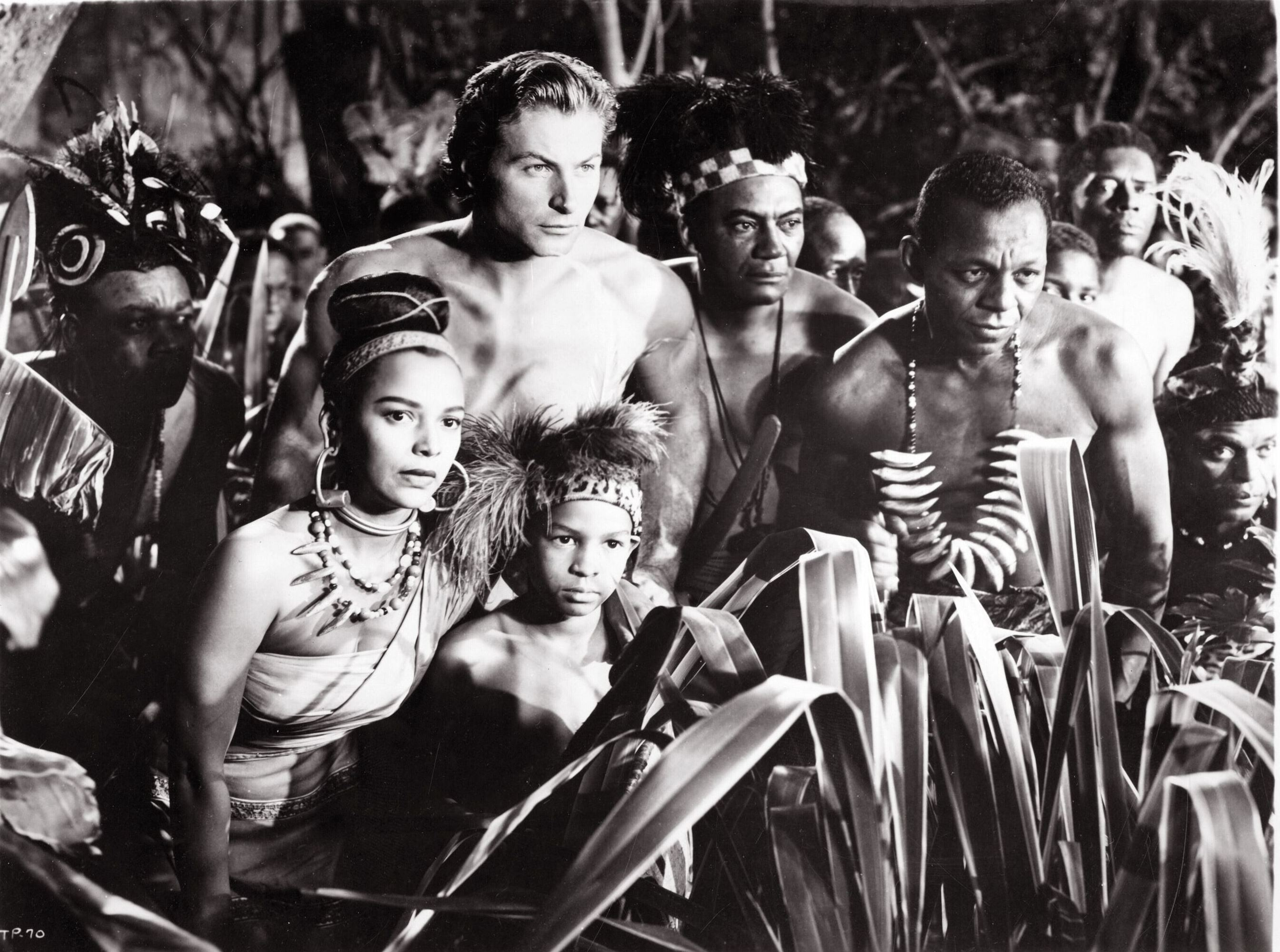 Tarzan (Lex Barker) (left of centre) comes to the aid of the natives in Tarzan's Peril (1951)