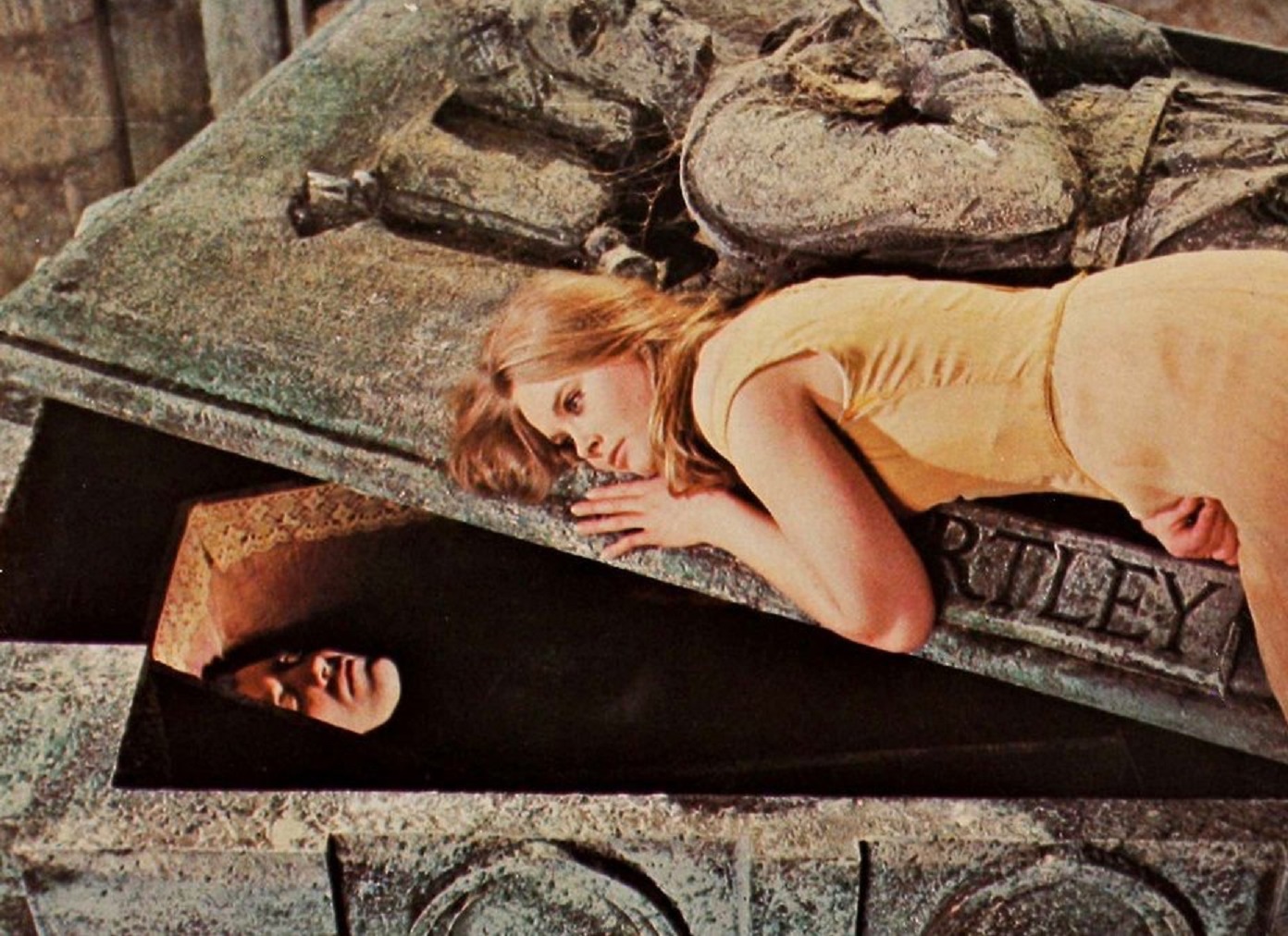 Linda Hayden curled up on Dracula (Christopher Lee)'s coffin in Taste the Blood of Dracula (1970)