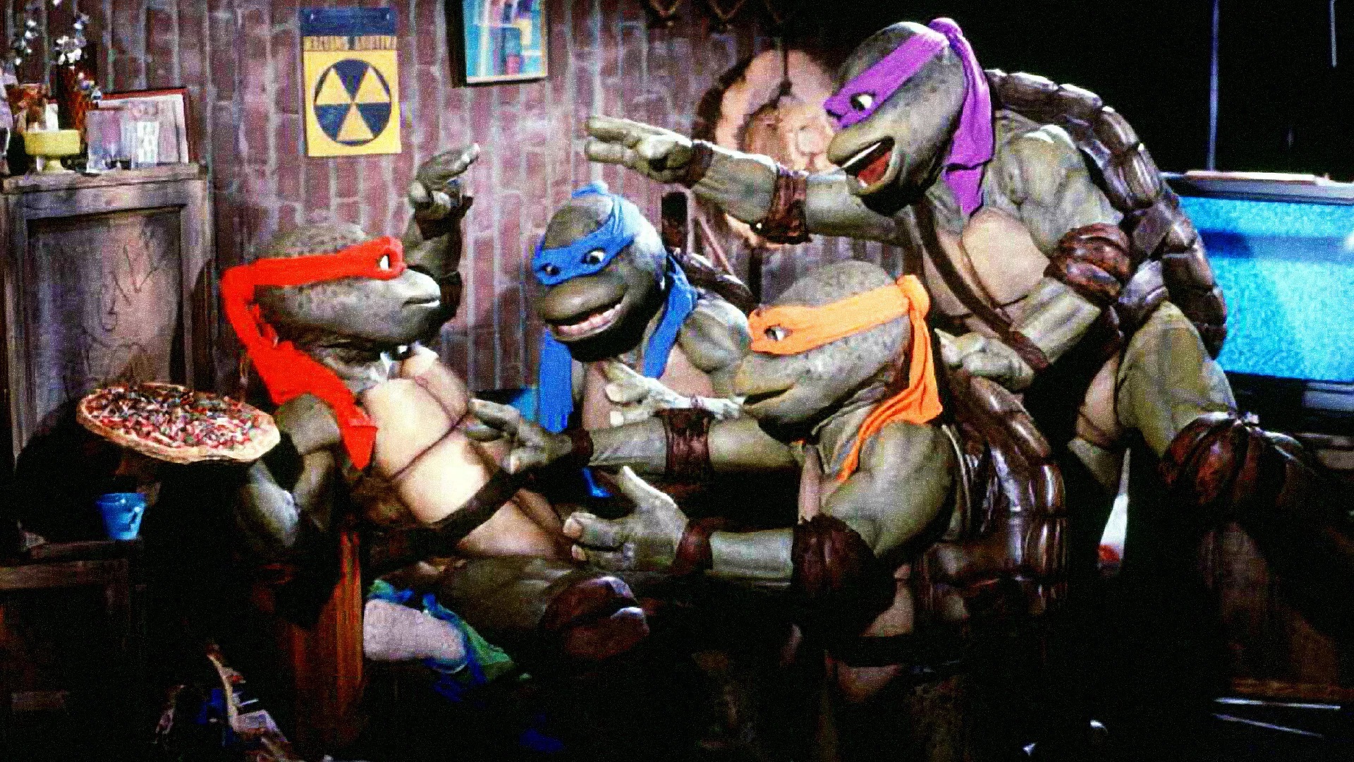 The Teenage Mutant Ninja Turtles - (l to r) Raphael, Leonardo, Michelangelo and Donatello - argue over pizza in Teenage Mutant Ninja Turtles II: The Secret of the Ooze (1991)