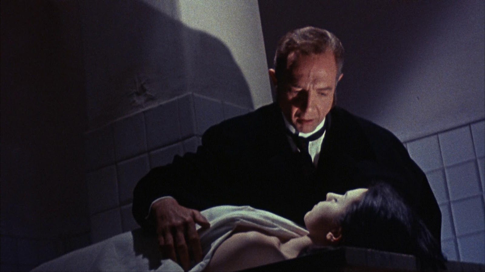 Dr Hichcock (Robert Flemyng) examines a body in The Terror of Dr Hichcock (1962)