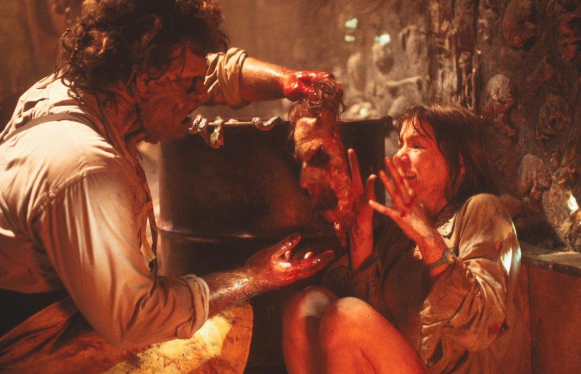 Leatherface (Bill Johnson) attempts to place a sliced-off human face on Caroline Williams in The Texas Chainsaw Massacre 2 (1986)