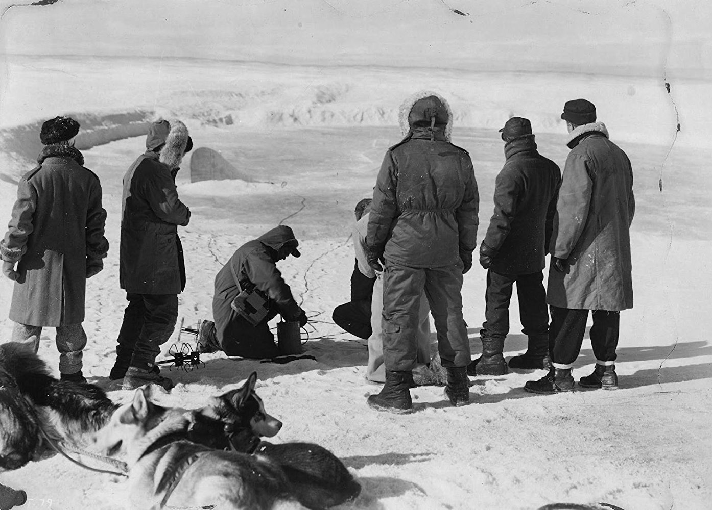 The men discover the saucer buried under the ice in The Thing from Another World (1951)