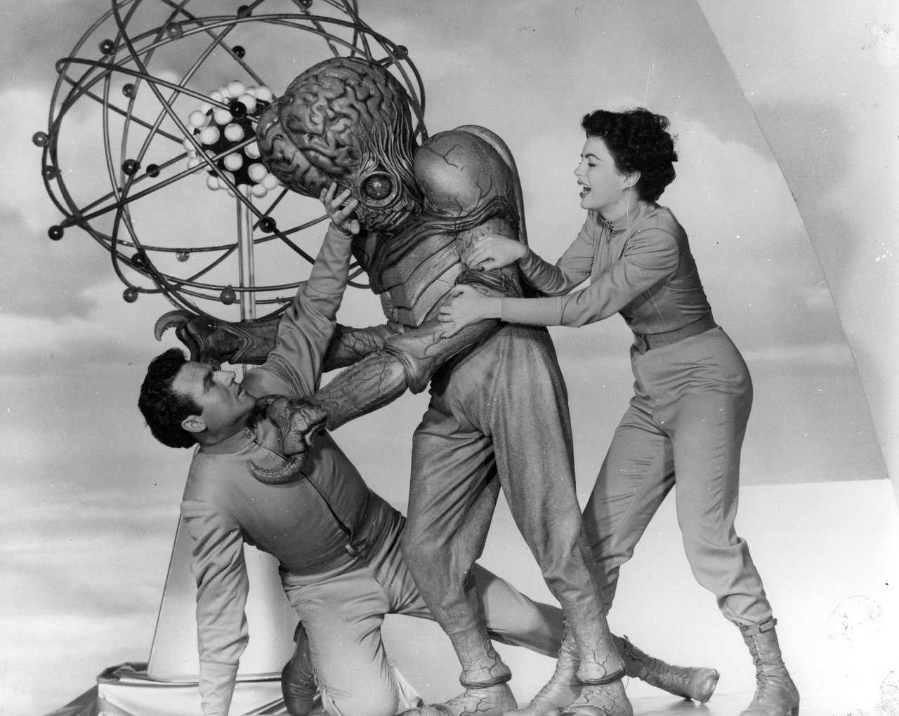 Rex Reason is attacked by  the mutant while Faith Domergue tries to help in This Island Earth (1955)