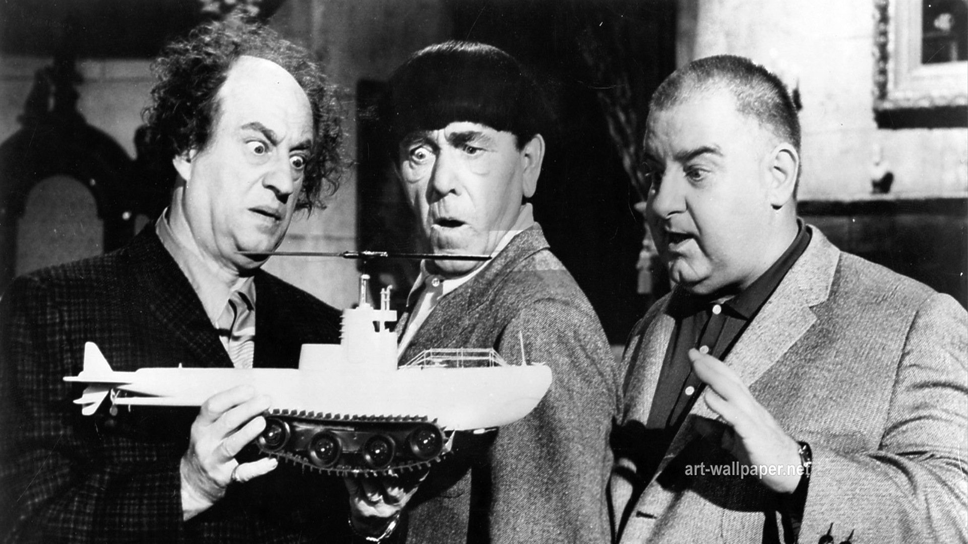 The Three Stooges - (l to r) Larry, Moe, Curly Joe holding the model of the tank/submarine/helicopter/rocketship in The Three Stooges in Orbit (1962)