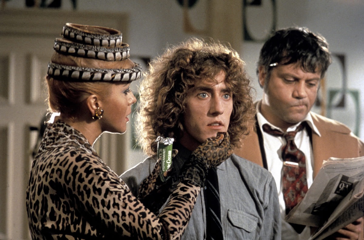 Tommy (Roger Daltrey) (c) flanked by his mother (Ann-Margret) and Cousin Frank (Oliver Reed) in Tommy (1975)