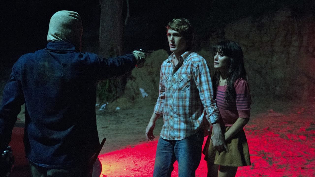 The new Phantom Killer menaces Spencer Treat Clark and Addison Timlin in The Town That Dreaded Sundown (2014)