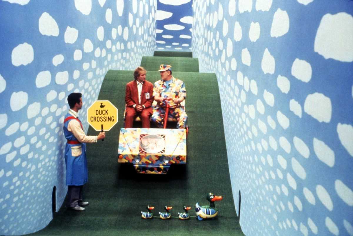 Robin Williams and Michael Gambon (seated l to r on golf cart) stop at the duck crossing in Toys (1992)