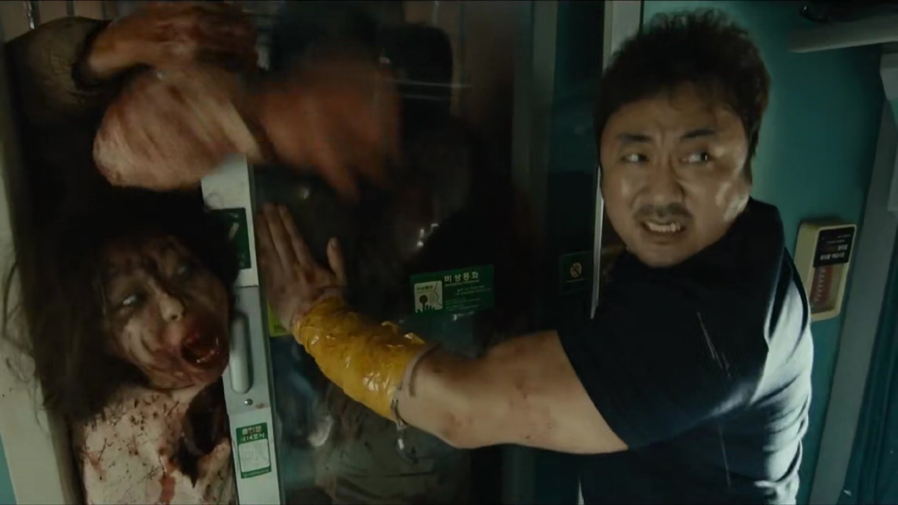 Dong-seok Ma tries to hold back the zombie horde in Train to Busan (2016)