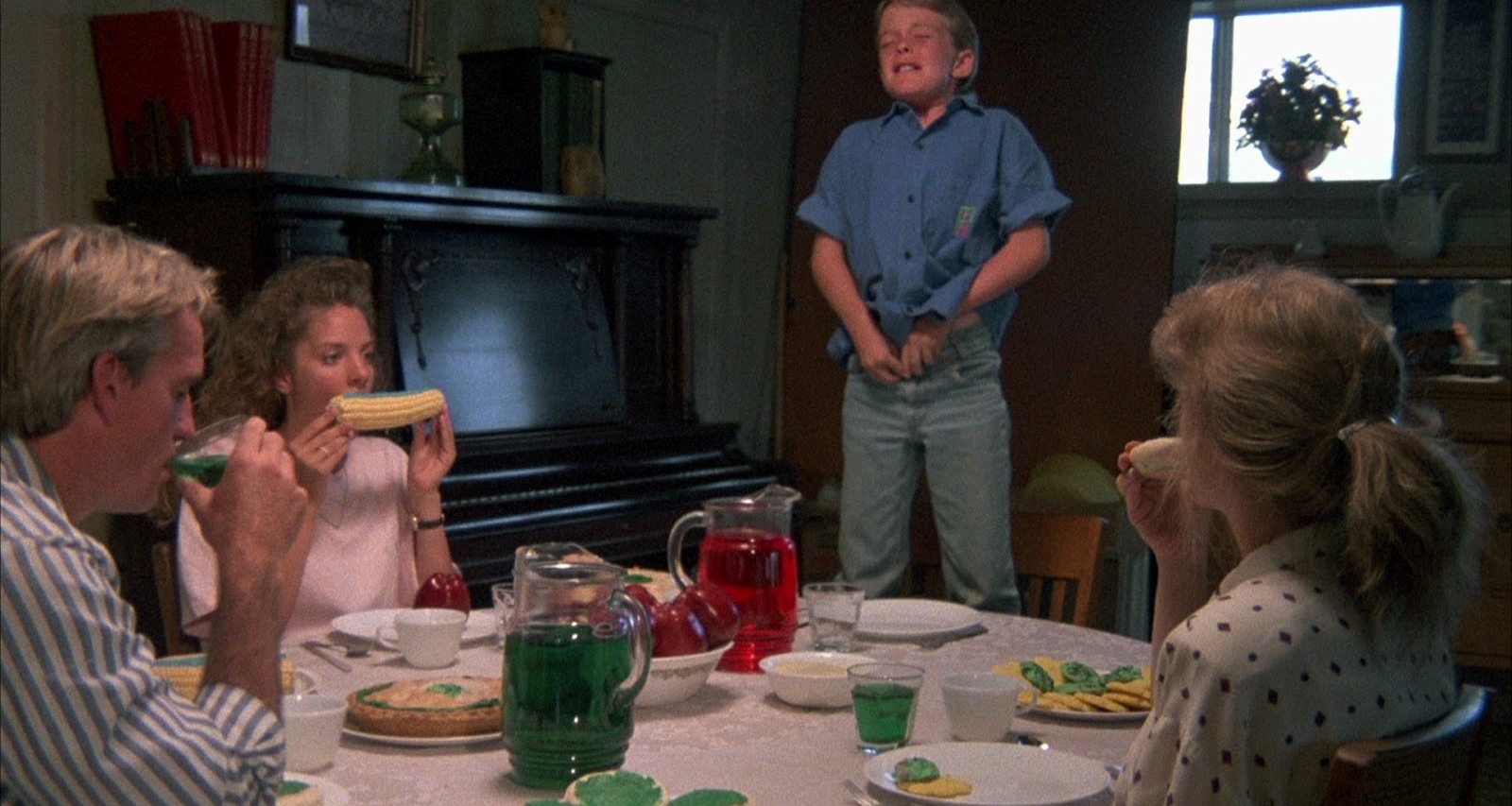 Michael Stephenson stands up to urinate on the table as father George Hardy, daughter Connie McFarland and mother Margo Prey sit down to eat dinner in Troll 2 (1990)