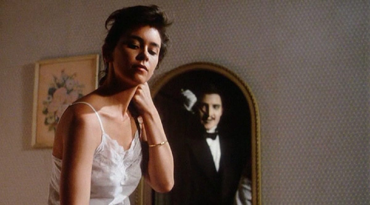 Jill Whitlow dresses while the ghost of Tyler Walker (Jonathan Chapin) lurks in the mirror in Twice Dead (1988)