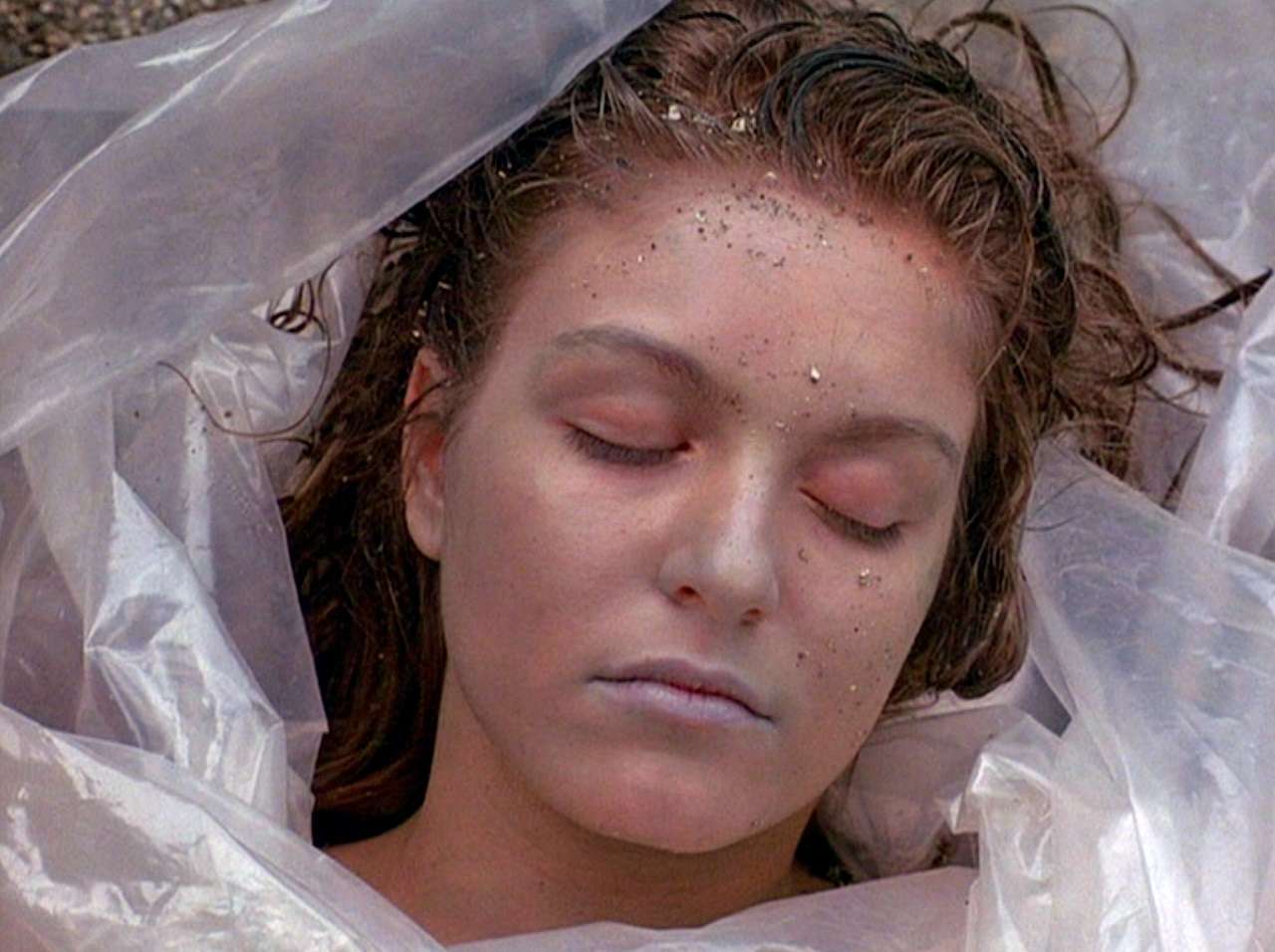 Laura Palmer (Sheryl Lee)'s dead body wrapped in plastic by the lakeside in Twin Peaks (1990)