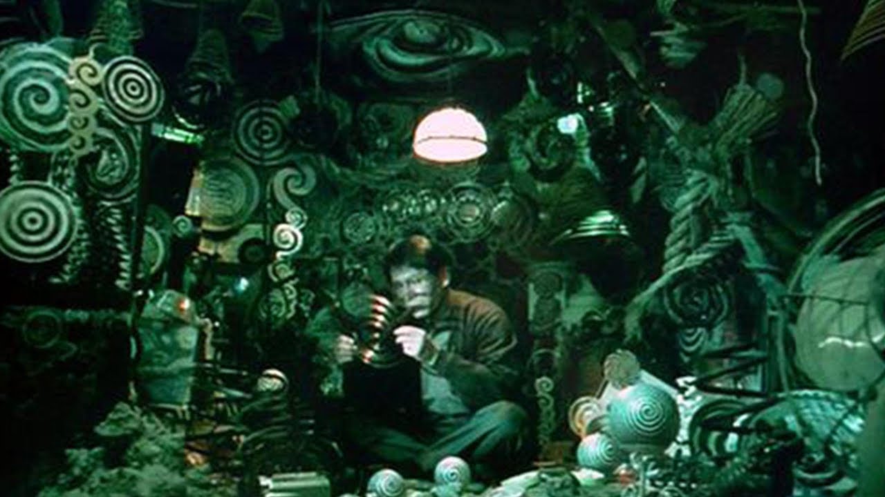 Ren Osugi surrounded by spiral patterns in Uzumaki (2000)