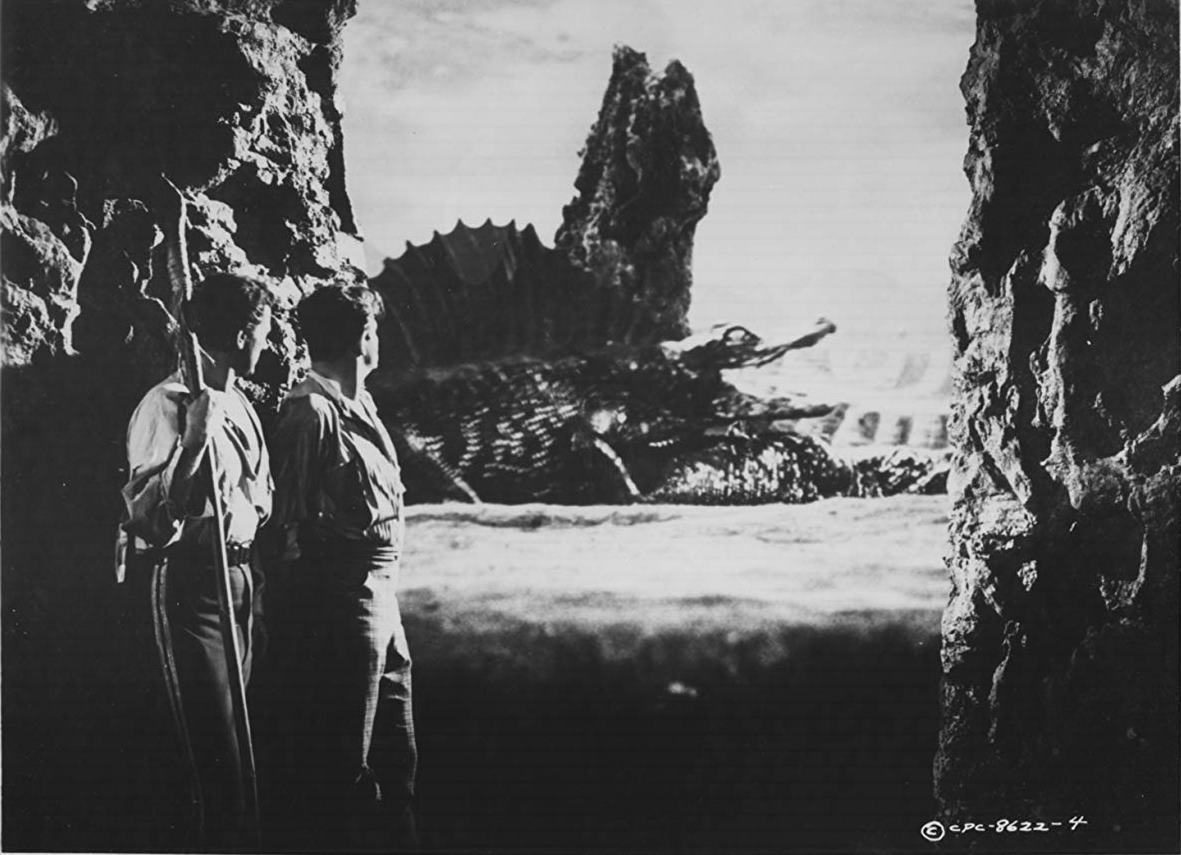 (l to r) Cesare Danova and Sean McClory view prehistoric life after being swept off on a comat in Valley of the Dragons (1961)