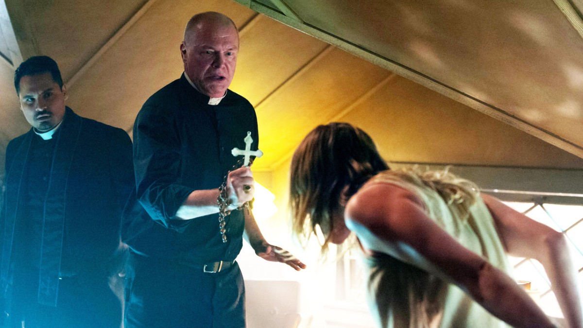 Priests Peter Andersson and Michael Peña attempt to exorcise Olivia Taylor Dudley in The Vatican Tapes (2015)