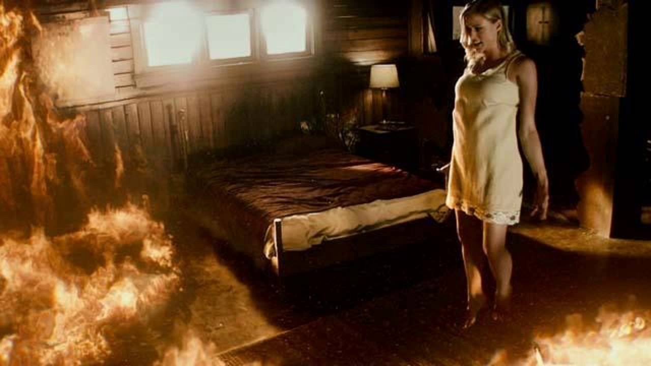 A possessed Olivia Taylor Dudley levitates in a burning house in The Vatican Tapes (2015)