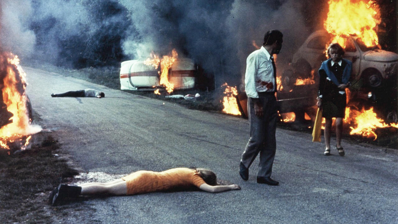 Jean Yanne and Mireille Darc pass through a traffic jam that becomes increasingly more apocalyptic in Weekend (1967)