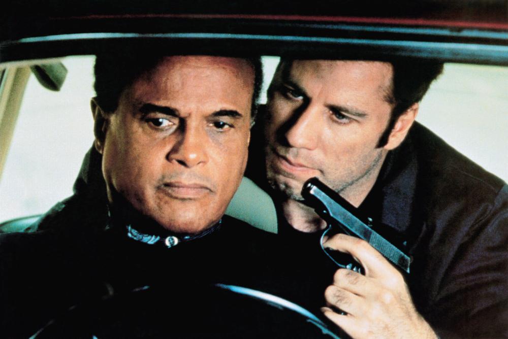 John Travolta (r) takes his boss Harry Belafonte (l) hostage at gunpoint in White Man's Burden (1995)