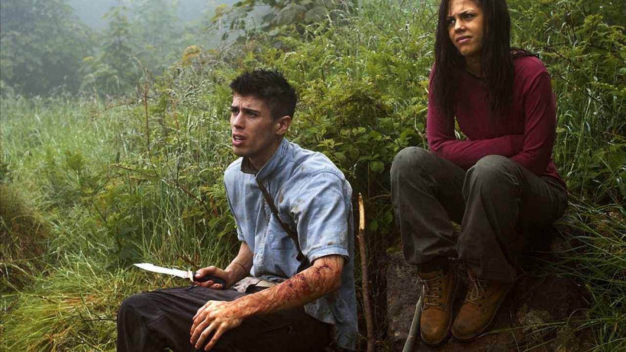 Toby Kebbll and Lenora Crichlow try to survive hunted on an island in Wilderness (2006)