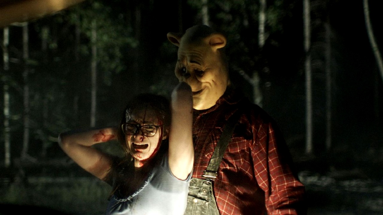 Winnie-the-Pooh (Craig David Dowsett) attacks Natasha Rose Mills in Winnie-the-Pooh: Blood and Honey (2023)