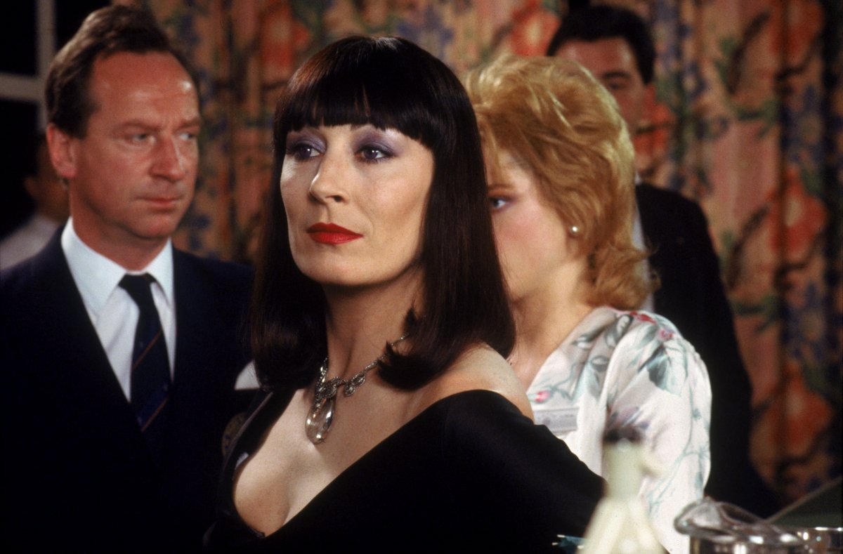 Anjelica Huston as Miss Ernst (c) with (behind l to r) Bill Paterson and Jane Horrocks in The Witches (1990)