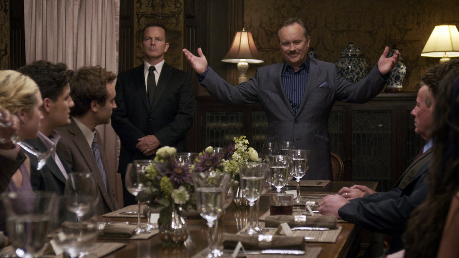 Millionaire Shepard Lambrick (Jeffrey Combs) introduces the contestants to his game over dinner in Would You Rather (2012)