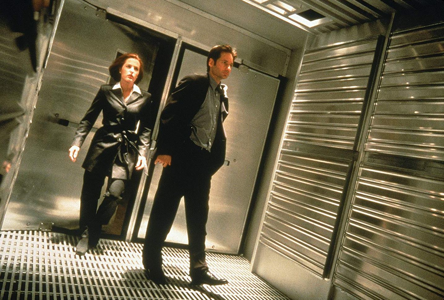 Agents Dana Scully (Gillian Anderson) and Fox Mulder (David Duchovny) enter the domes in The X Files (1998)