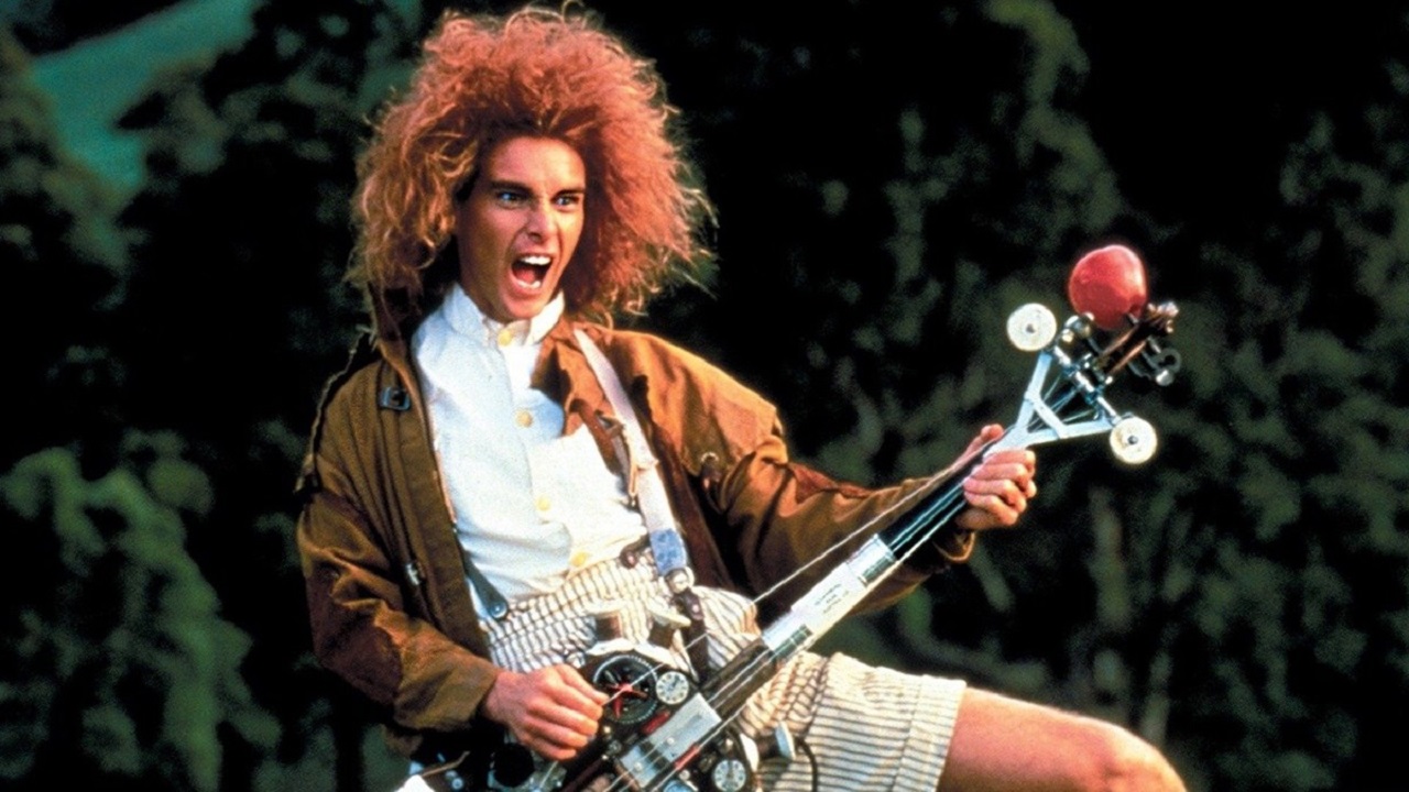 Yahoo Serious as Albert Einstein with homemade electric guitar discovers rock music in Young Einstein (1988)