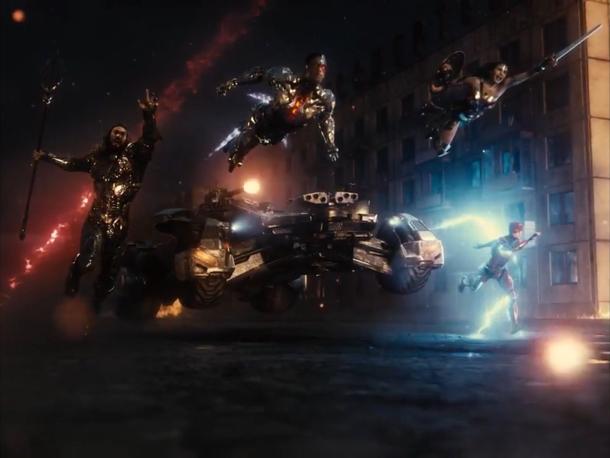 (l to r) Aquaman (Jason Momoa), Cyborg (Ray Fisher), Wonder Woman (Gal Gadot) and The Flash (Ezra Miller), along with the Batmobile head off into action in Russia in Zack Snyder's Justice League (2021)