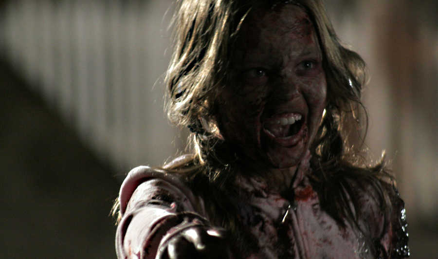 Zombie Sydney Sweeney attacks in Zombies of Mass Destruction (2009)