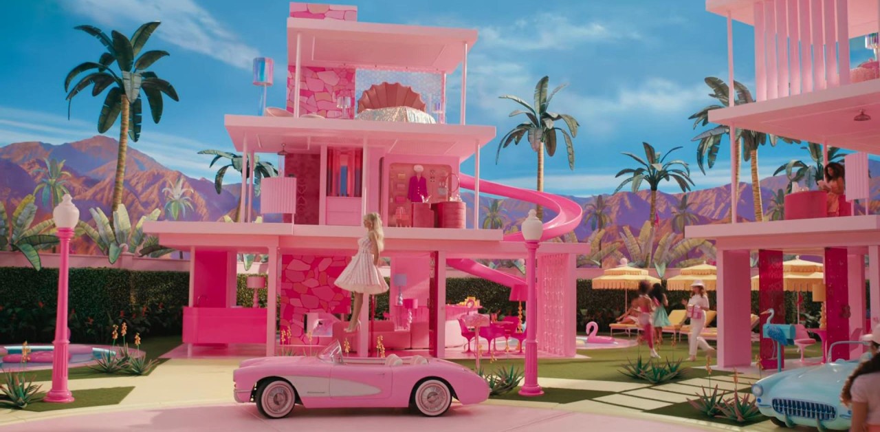 Barbie (Margot Robbie) floats down to her car from her home in Barbieland