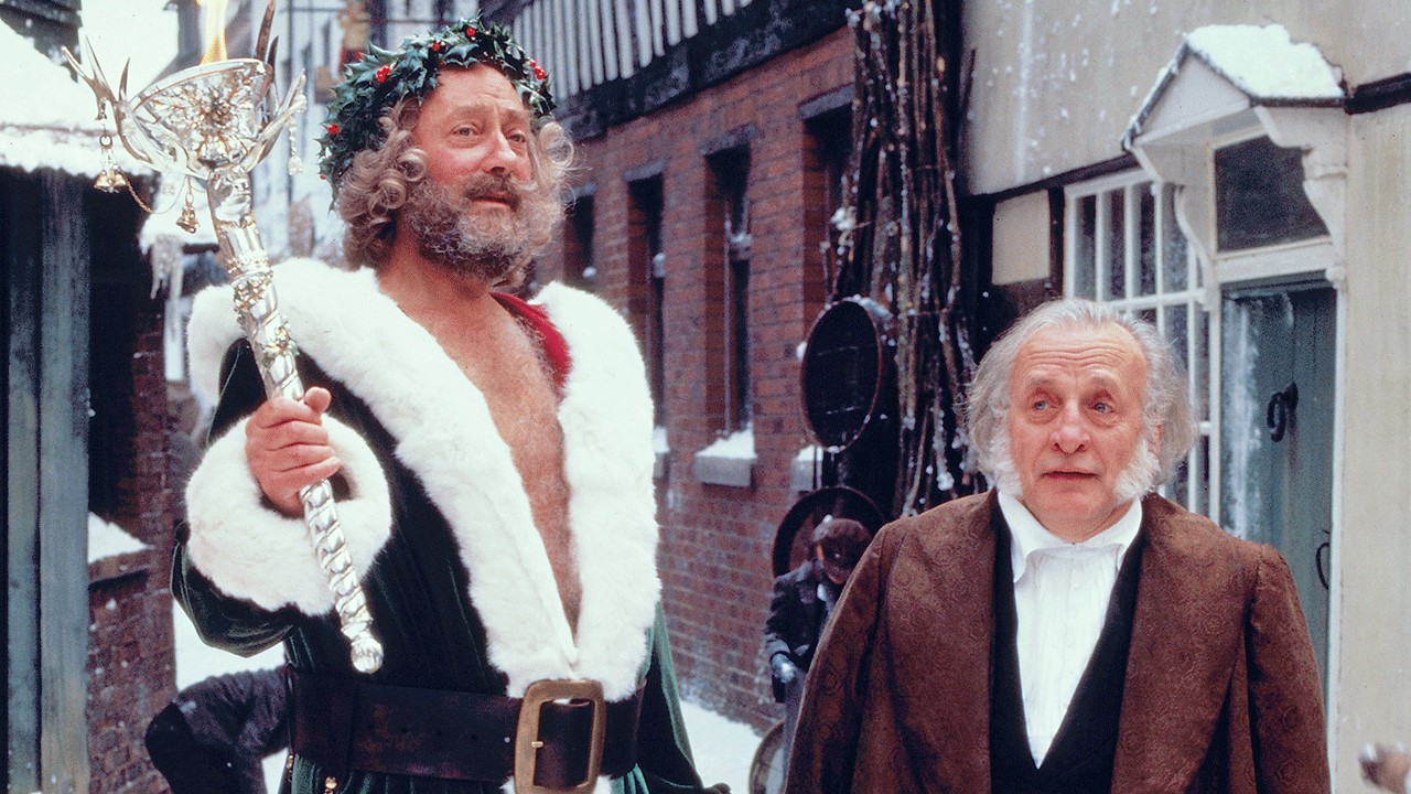 Ebenezer Scrooge (George C. Scott) and Ghost of Christmas Present (Edward Woodward) in A Christmas Carol (1984)